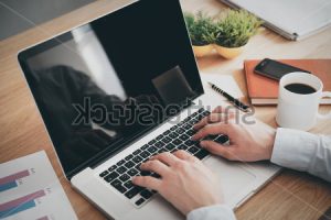 stock-photo-businessman-at-work-close-up-top-view-of-man-working-on-laptop-while-sitting-at-the-wooden-desk-272975228